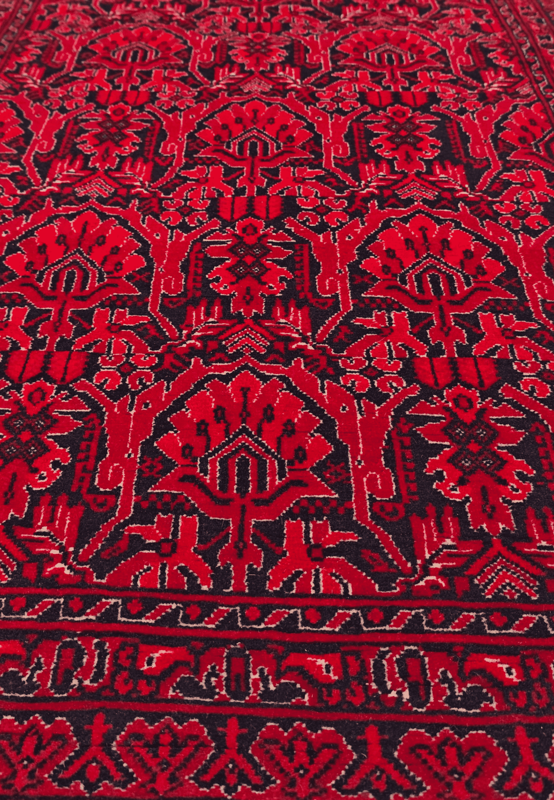 Hand-knotted Khal Mohammadi rug on deep madder red