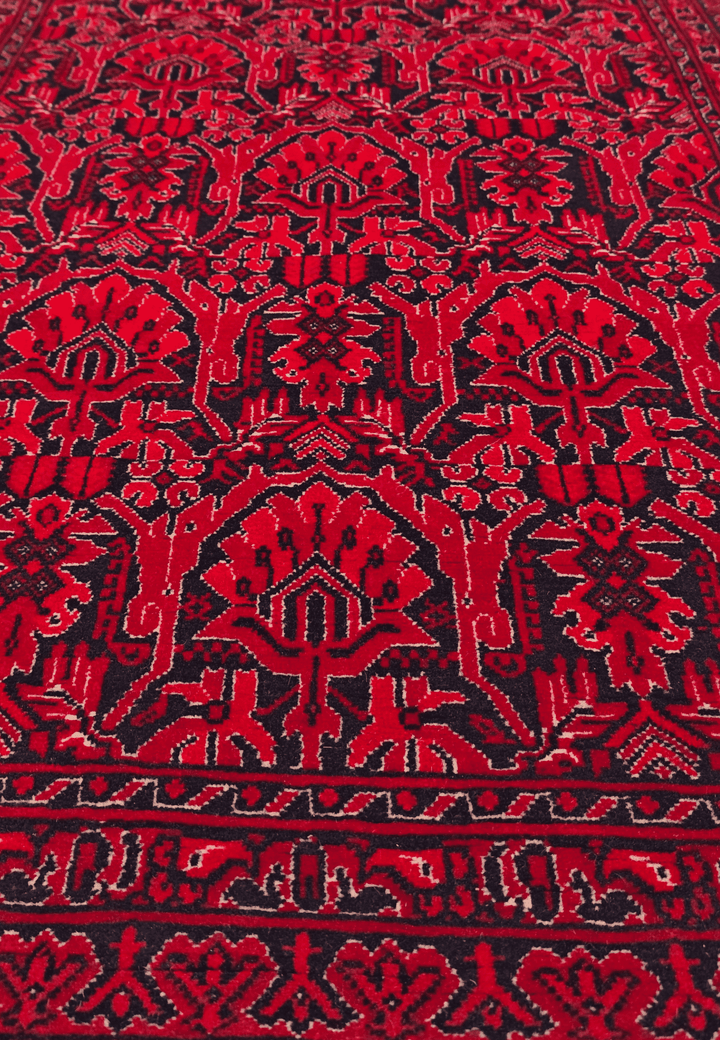 Hand-knotted Khal Mohammadi rug on deep madder red