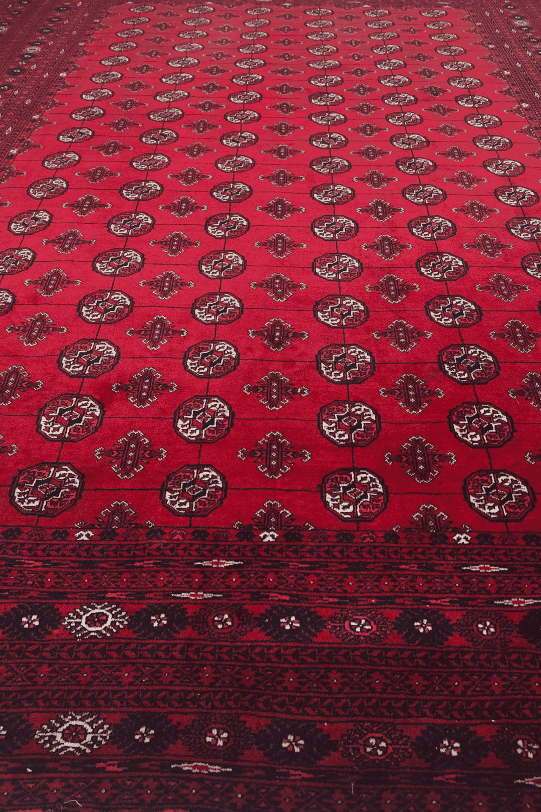 Hand-knotted wine red Sherwan rug with Turkmen gül field