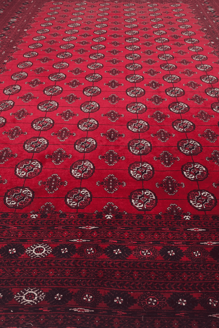 Hand-knotted wine red Sherwan rug with Turkmen gül field