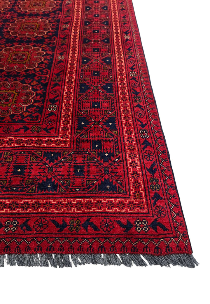 Corner of wine red Bashiri hand-knotted Afghan rug