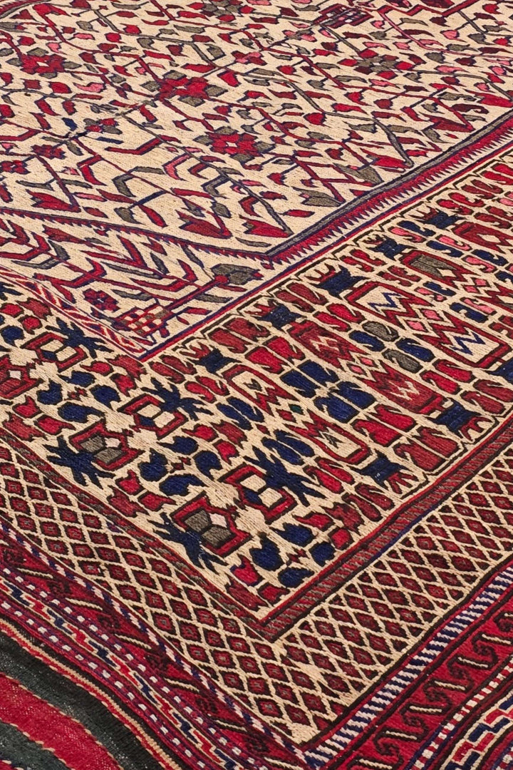 Hooked medallion detail in cream and red on Afghan kilim