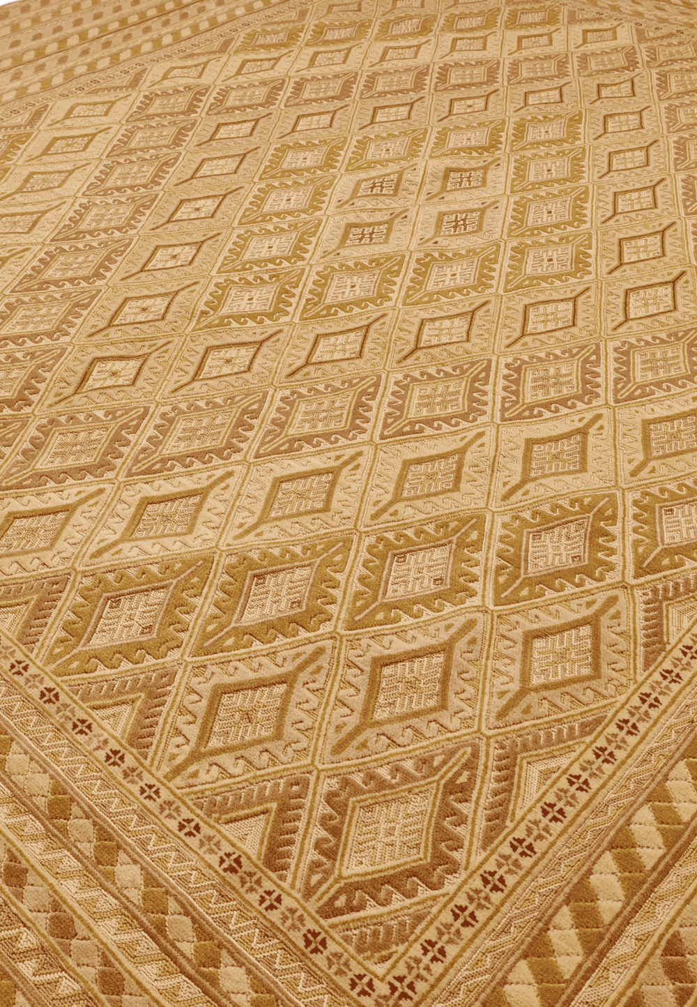 Diamond lattice detail in gold and cream on Afghan kilim