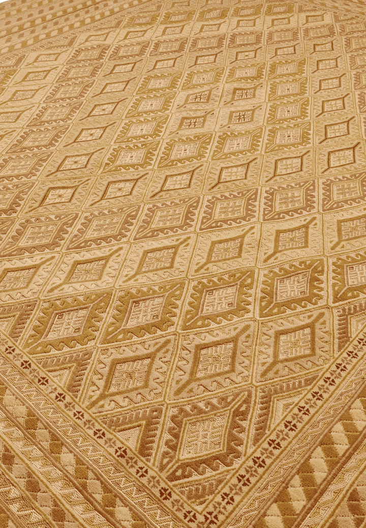 Diamond lattice detail in gold and cream on Afghan kilim
