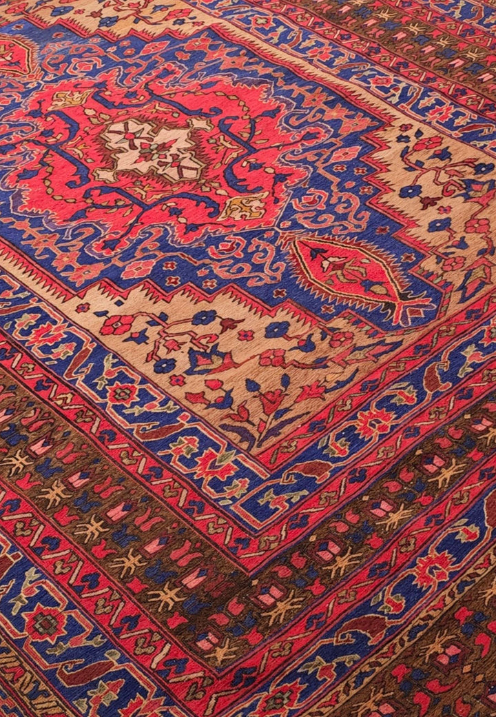 Medallion detail in scarlet and cobalt on Afghan kilim