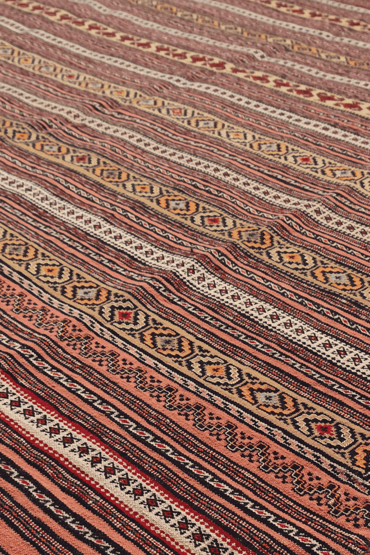 Maliki pattern detail in rust and cream on Afghan kilim