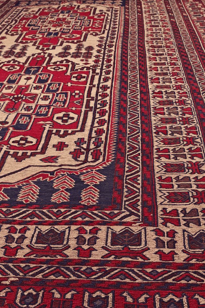 Stepped Turkmen medallion detail in deep red and camel on kilim