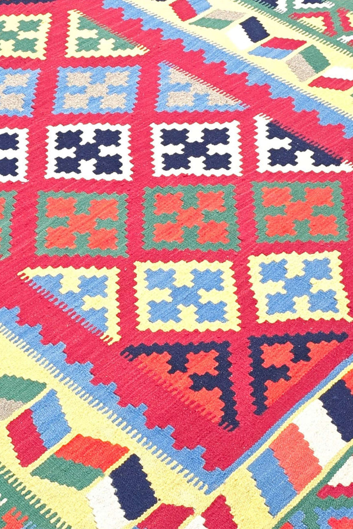 Qashqai medallion detail in cerise and green on Afghan kilim
