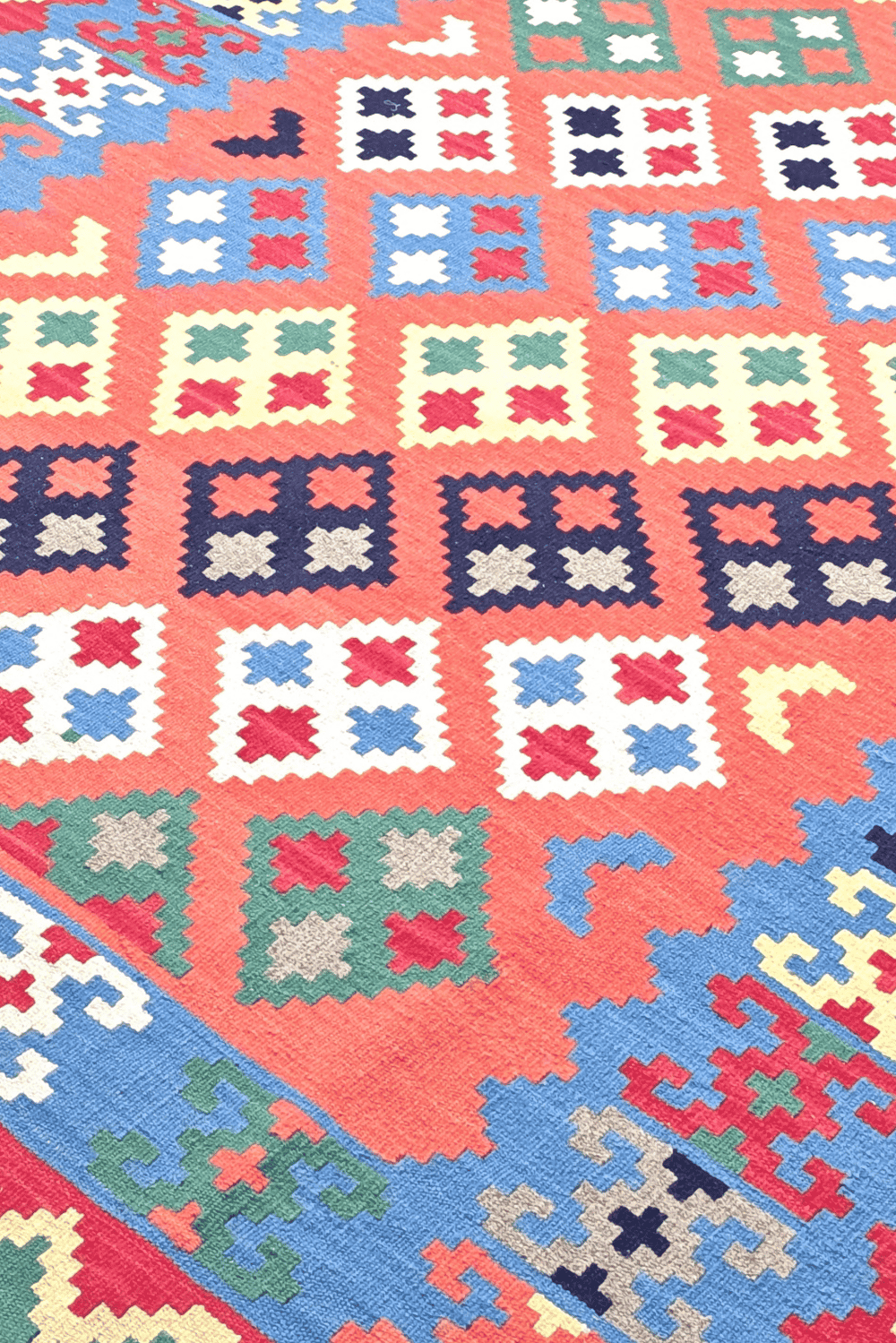 Qashqai diamond detail in coral and green on Afghan kilim