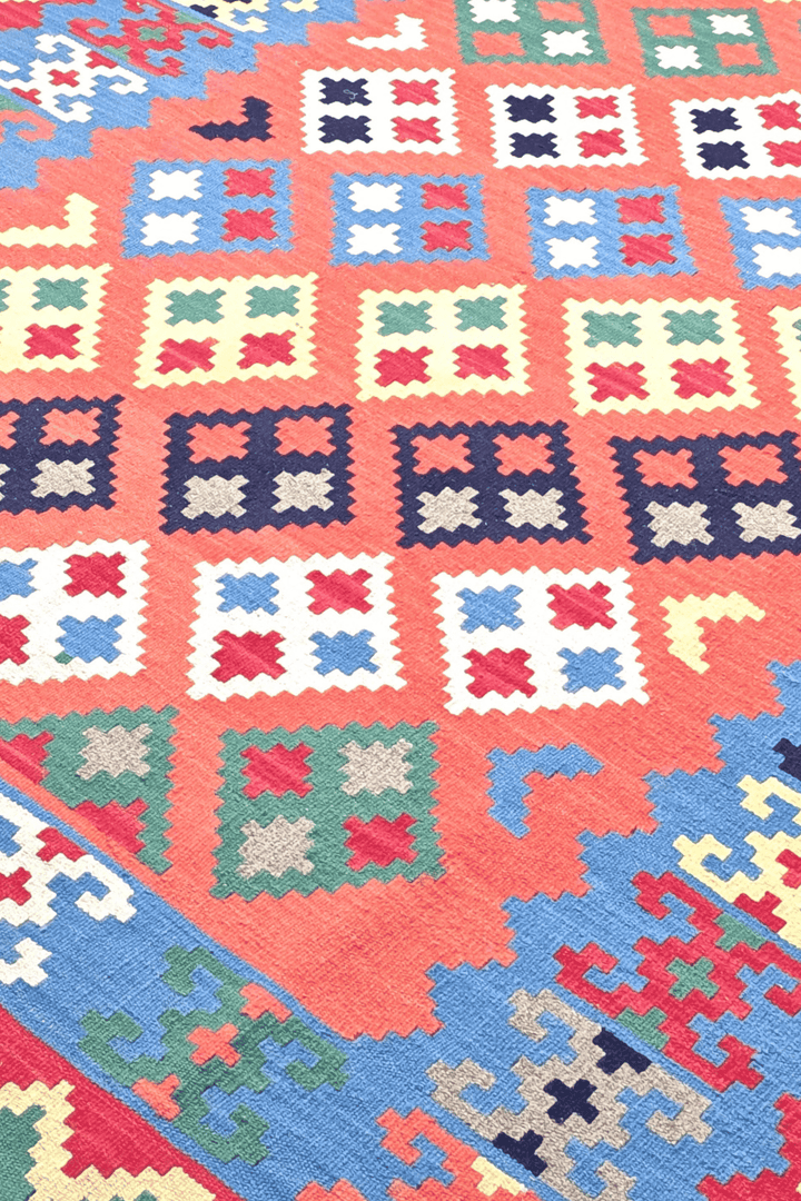 Qashqai diamond detail in coral and green on Afghan kilim