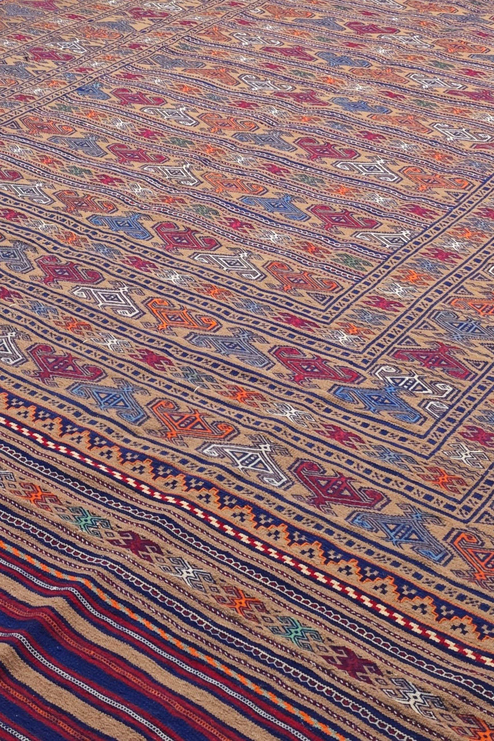 Banded detail in camel and burgundy on Afghan kilim