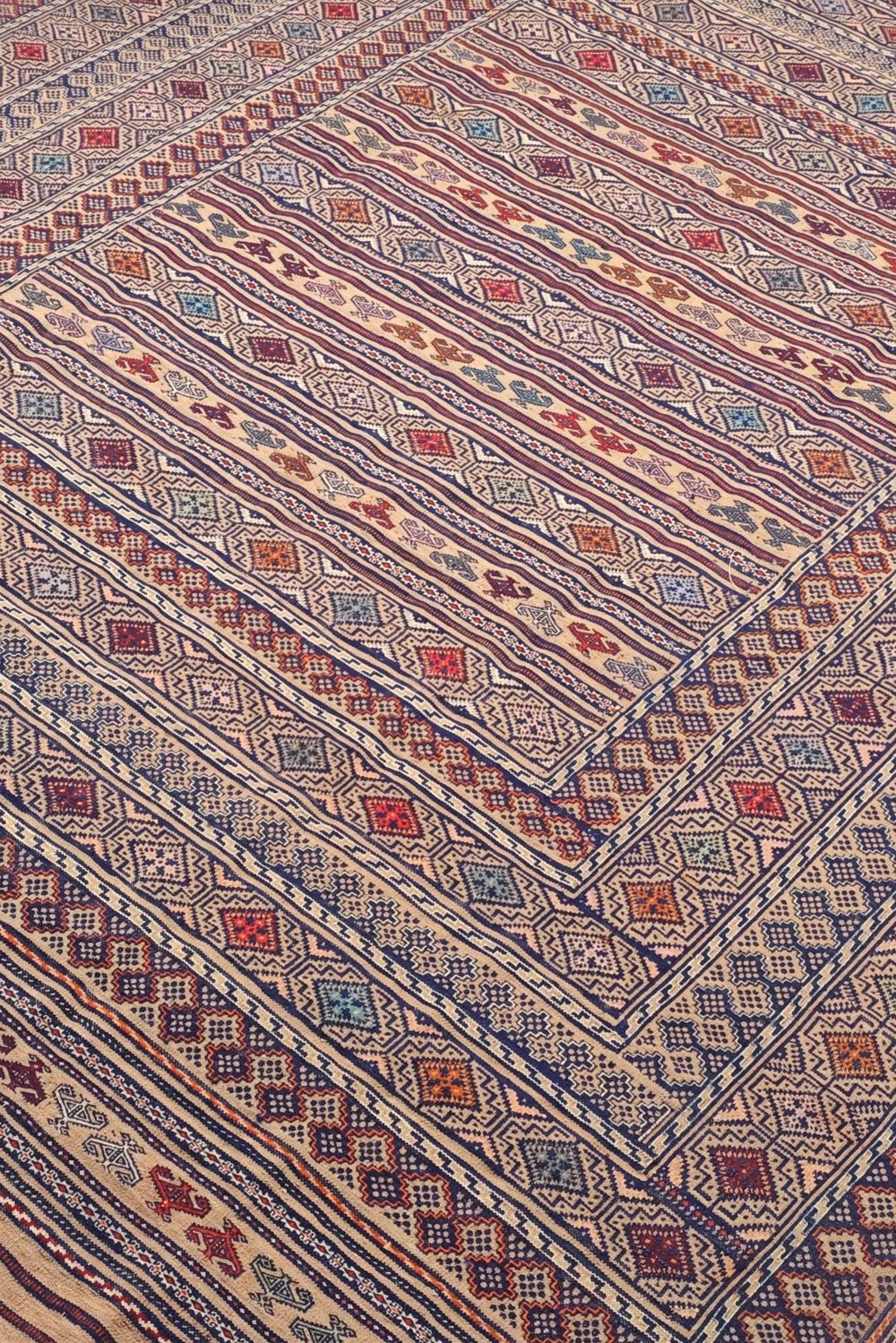 Banded detail in camel and indigo on Afghan kilim