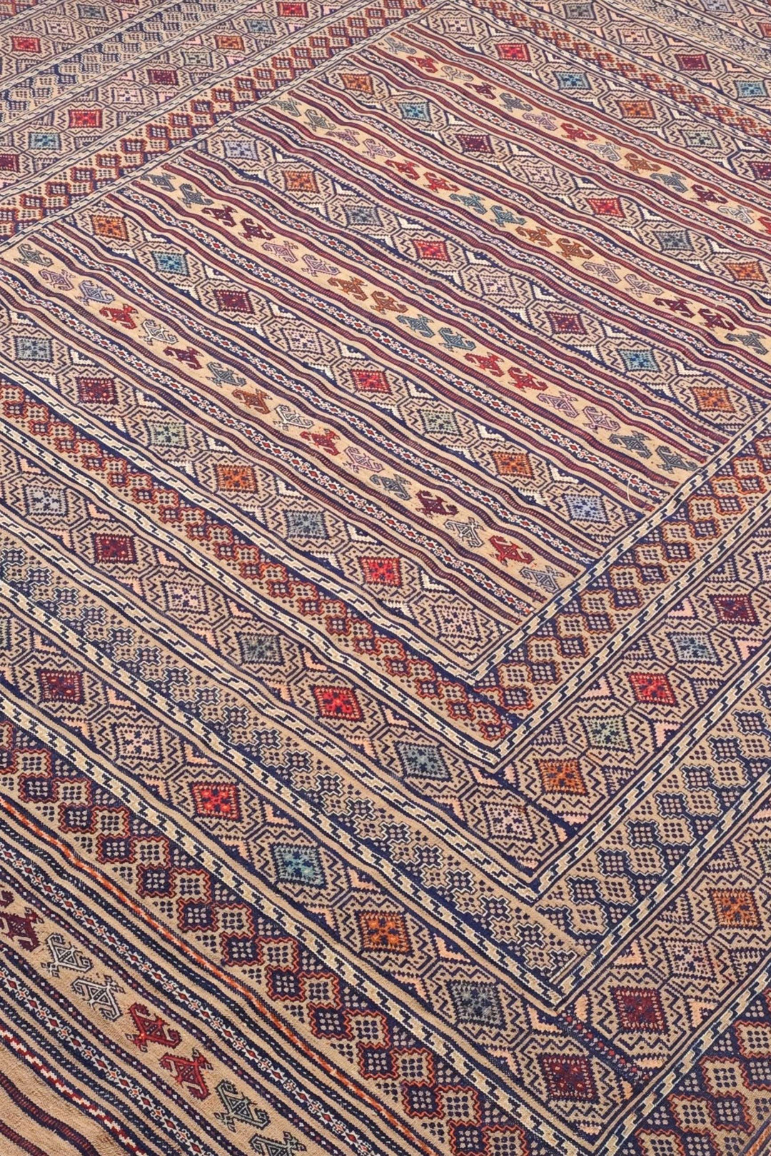 Banded detail in camel and indigo on Afghan kilim