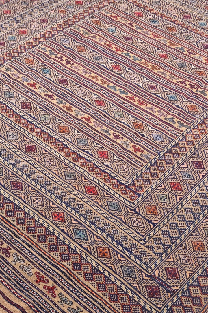 Banded detail in camel and indigo on Afghan kilim