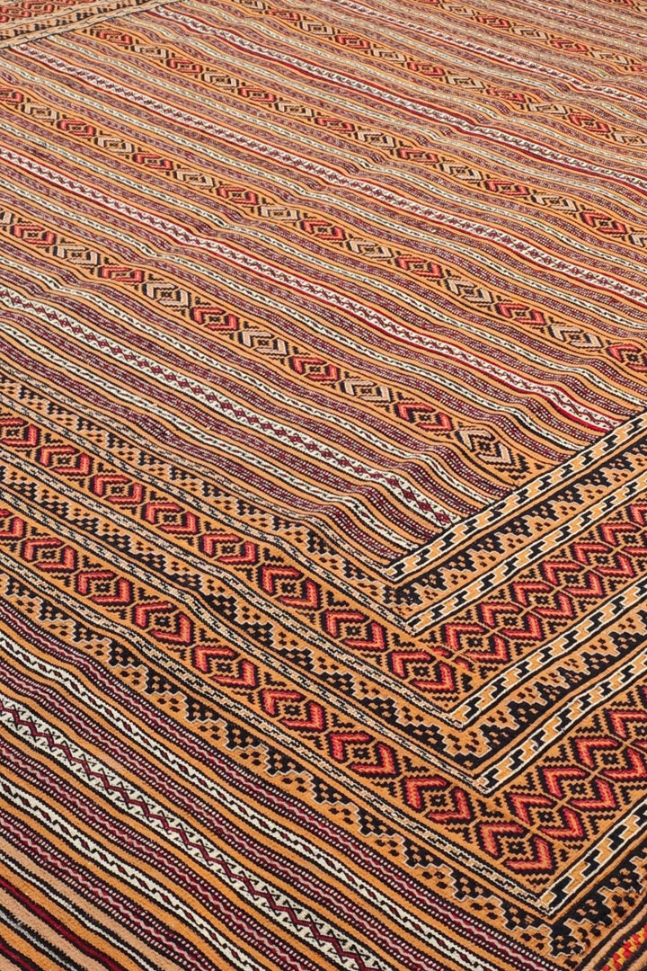 Banded detail in terracotta and apricot on Afghan kilim
