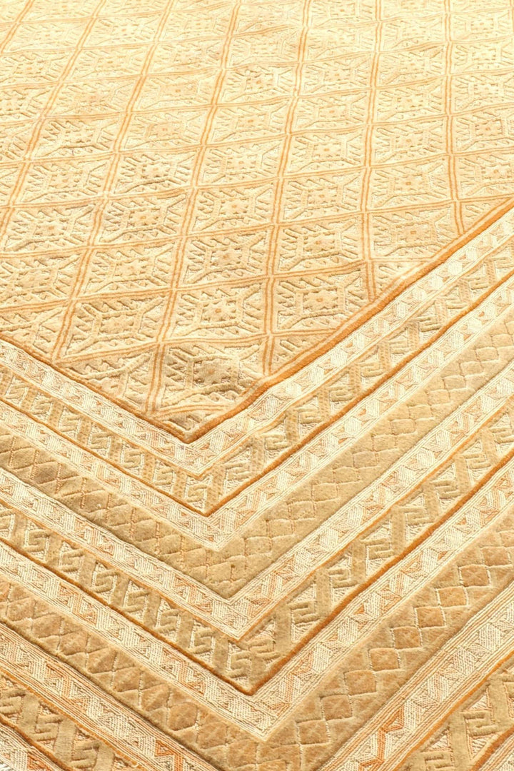 Diamond lattice detail in pale gold and cream on Afghan kilim