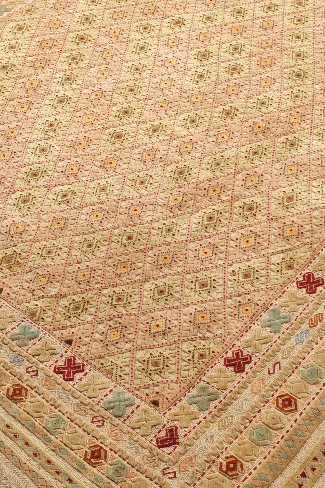 Diamond lattice detail in wheat gold and cream on Afghan kilim