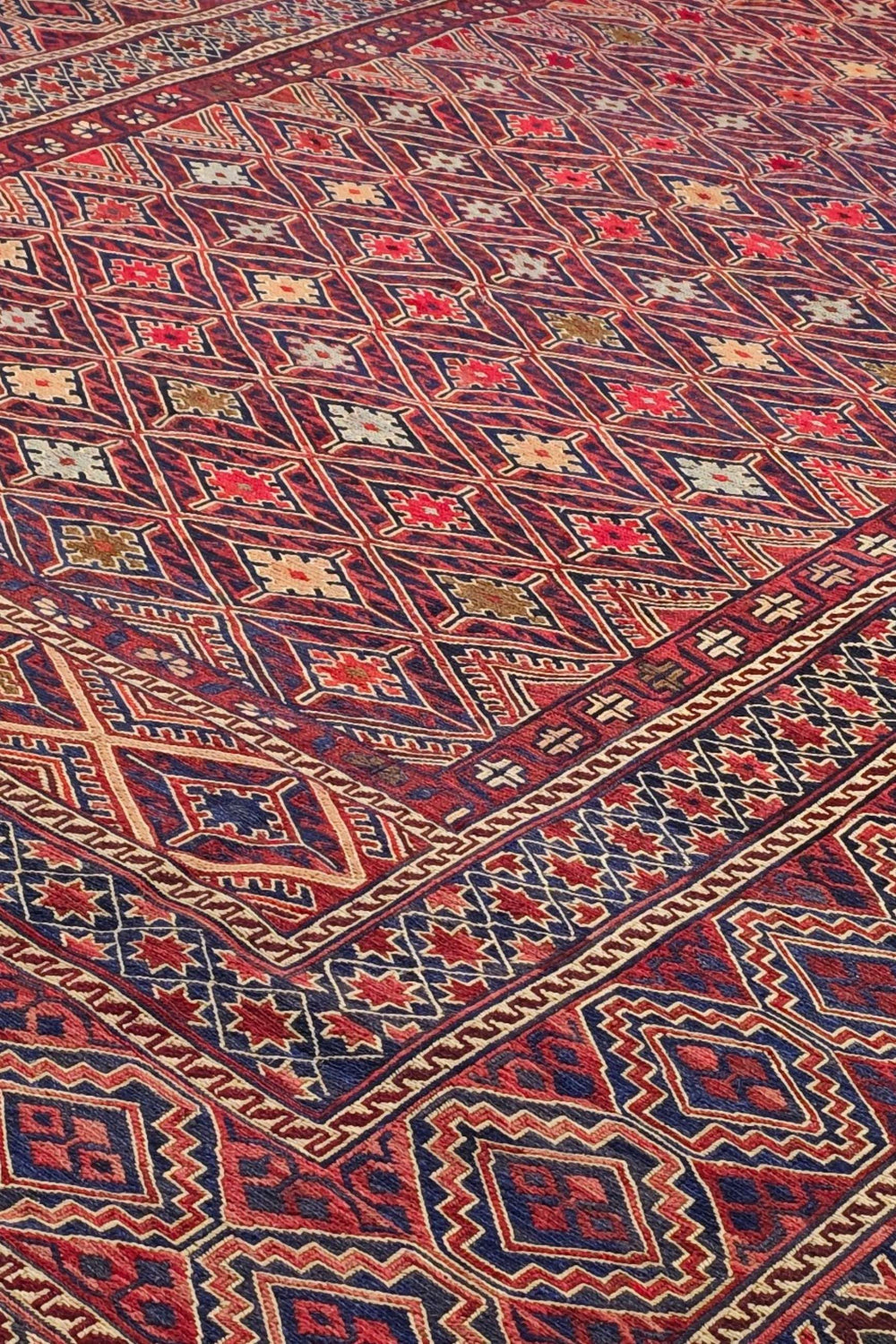 Diamond lattice detail in red and ivory on Afghan kilim