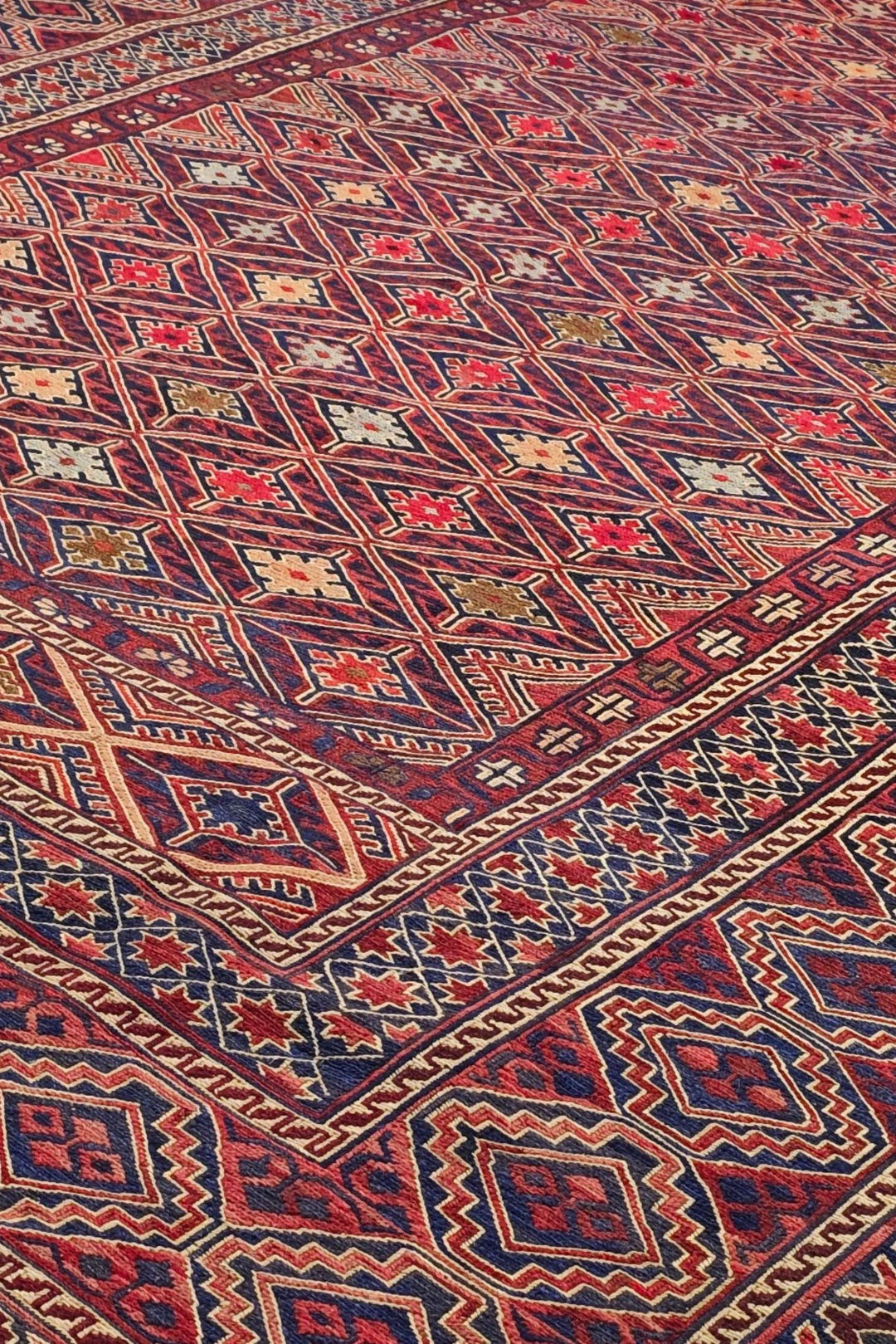 Diamond lattice detail in red and ivory on Afghan kilim