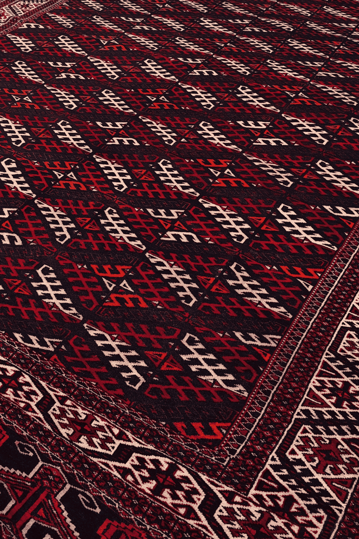 Turkmen panel design in aubergine and ivory on Afghan wool rug