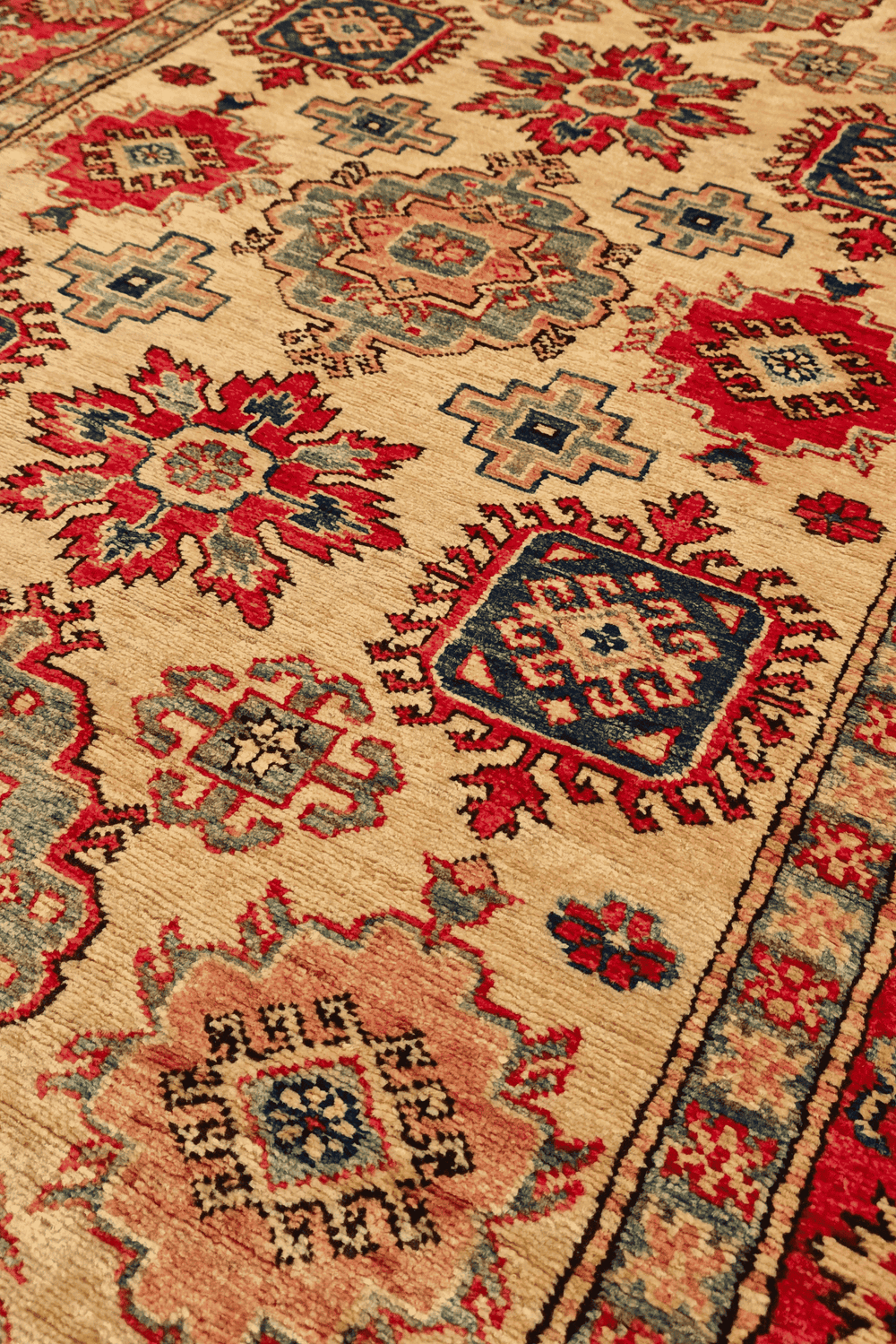 Sunburst medallion detail in gold and red on Afghan Sherwan rug