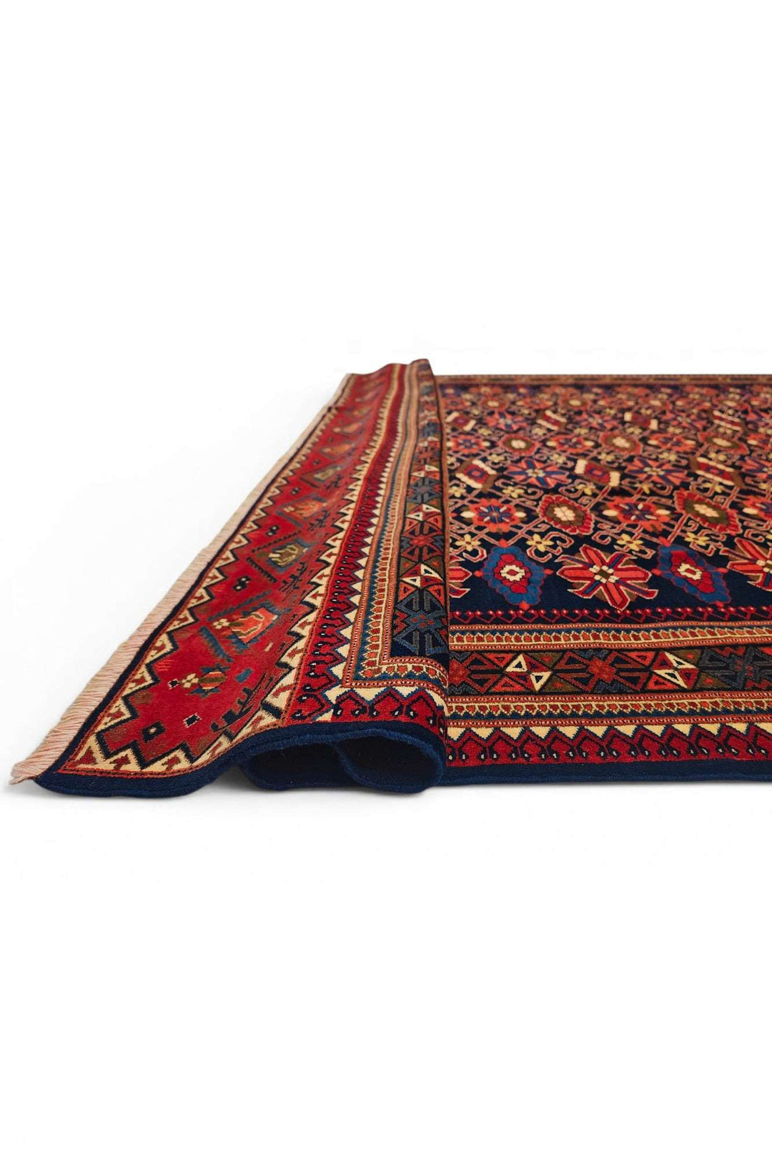Corner of indigo and red all-over floral Afghan Sherwan rug