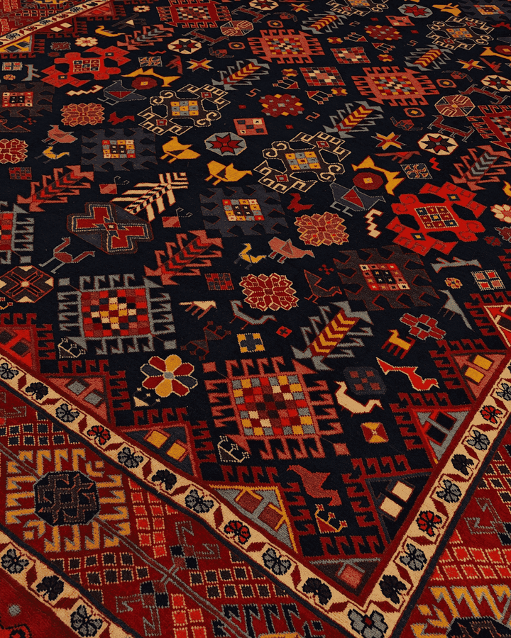 Border detail of indigo Caucasian hand-knotted Afghan rug