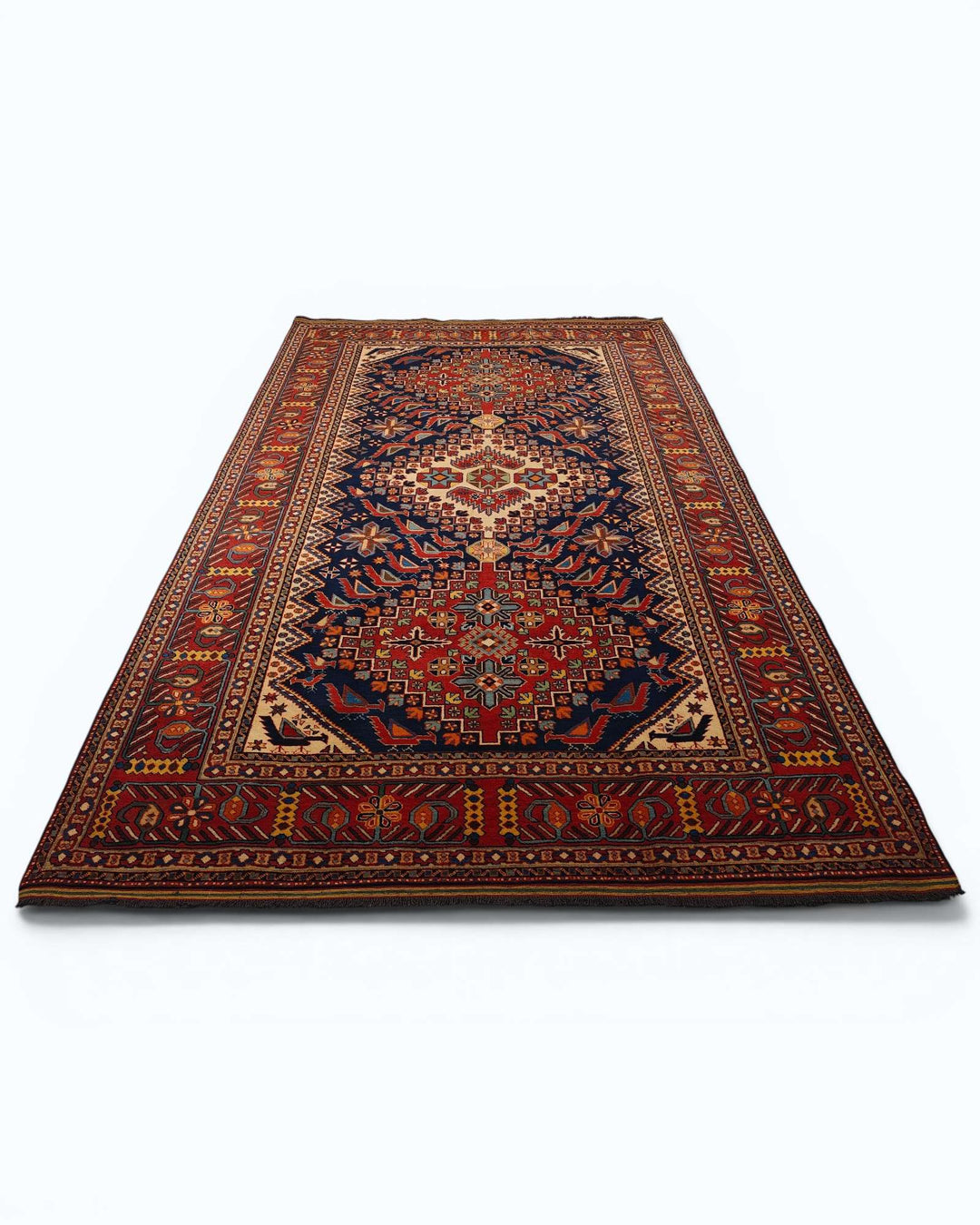 Hand-knotted wool pile of indigo Caucasian Afghan rug