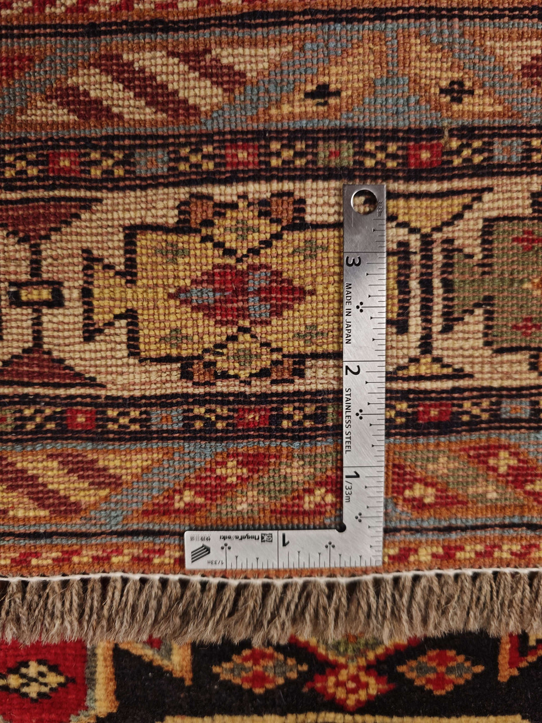 Corner of red and indigo Chi-Chi Afghan hand-knotted rug