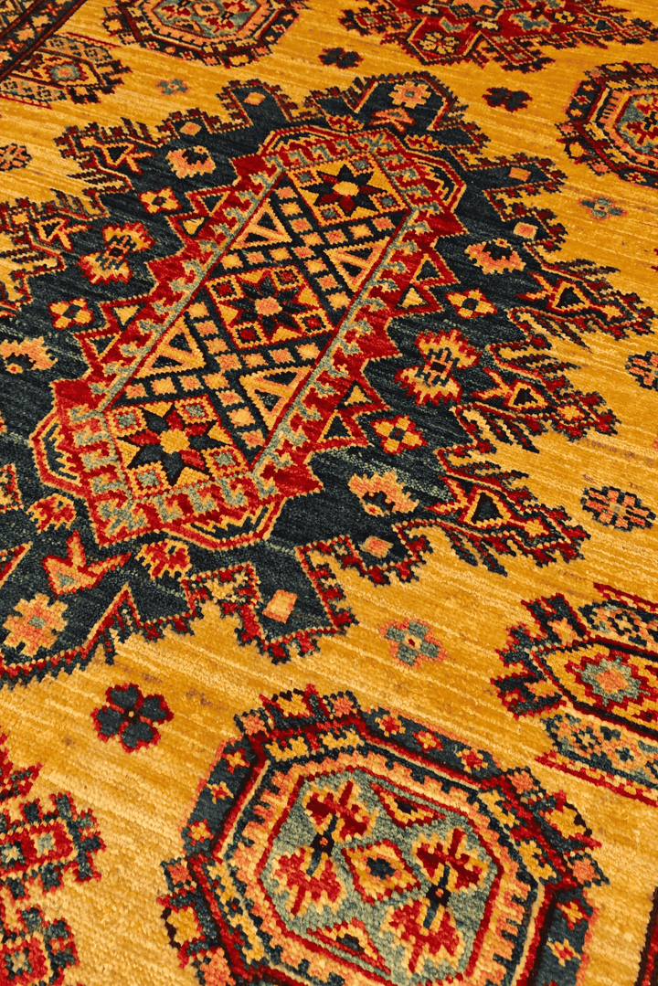 Border detail of marigold hand-knotted Afghan Sherwan rug