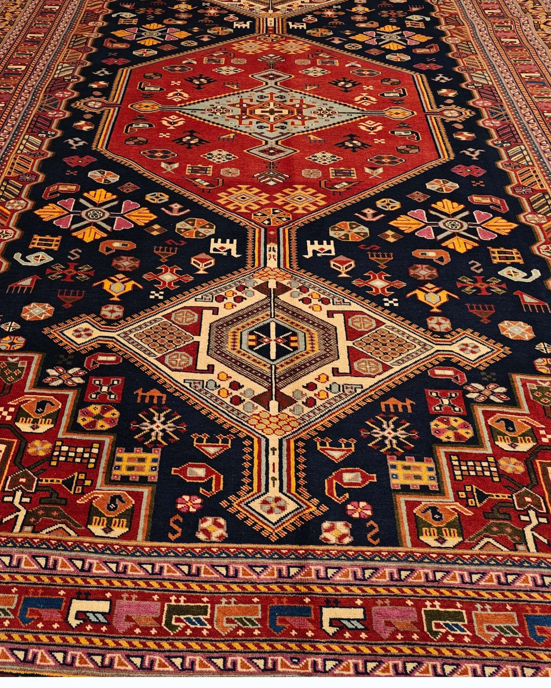 Hand-knotted wool pile of navy Khamseh Afghan Sherwan rug