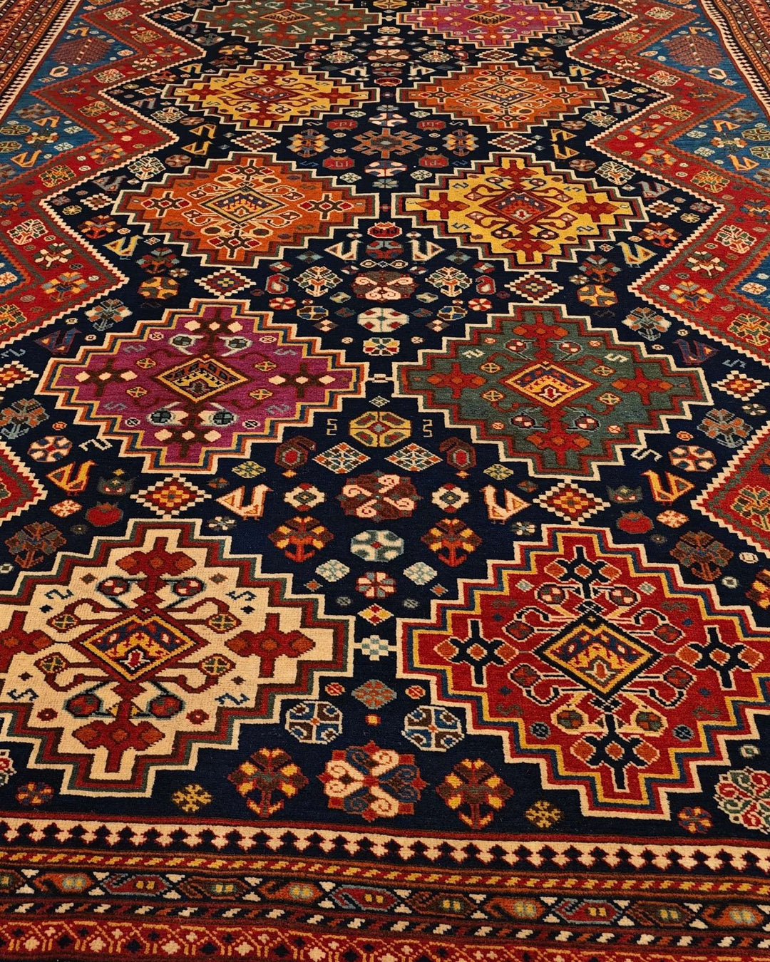 Border detail of navy and red Kashkuli hand-knotted Afghan rug