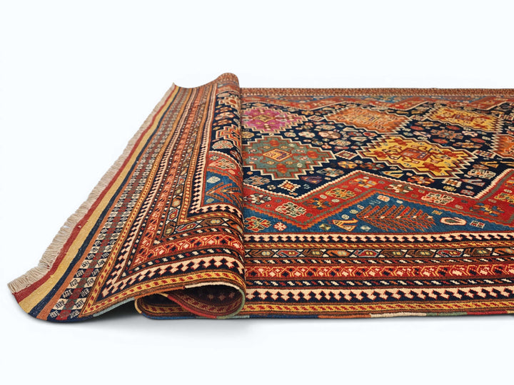 Corner of navy and red Kashkuli Afghan hand-knotted rug