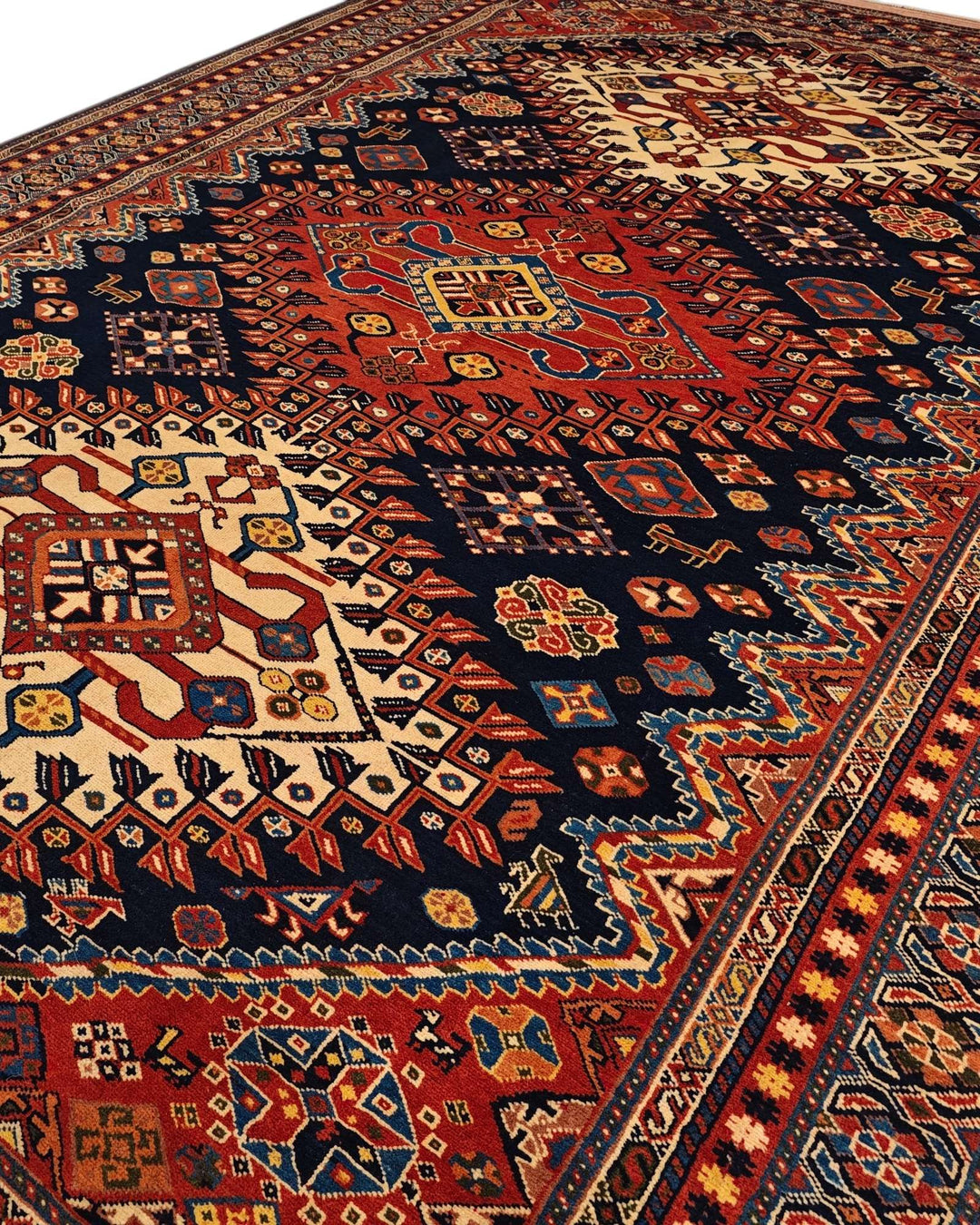 Border detail of navy and red Yalameh hand-knotted Afghan rug