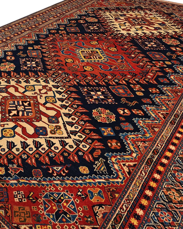 Border detail of navy and red Yalameh hand-knotted Afghan rug