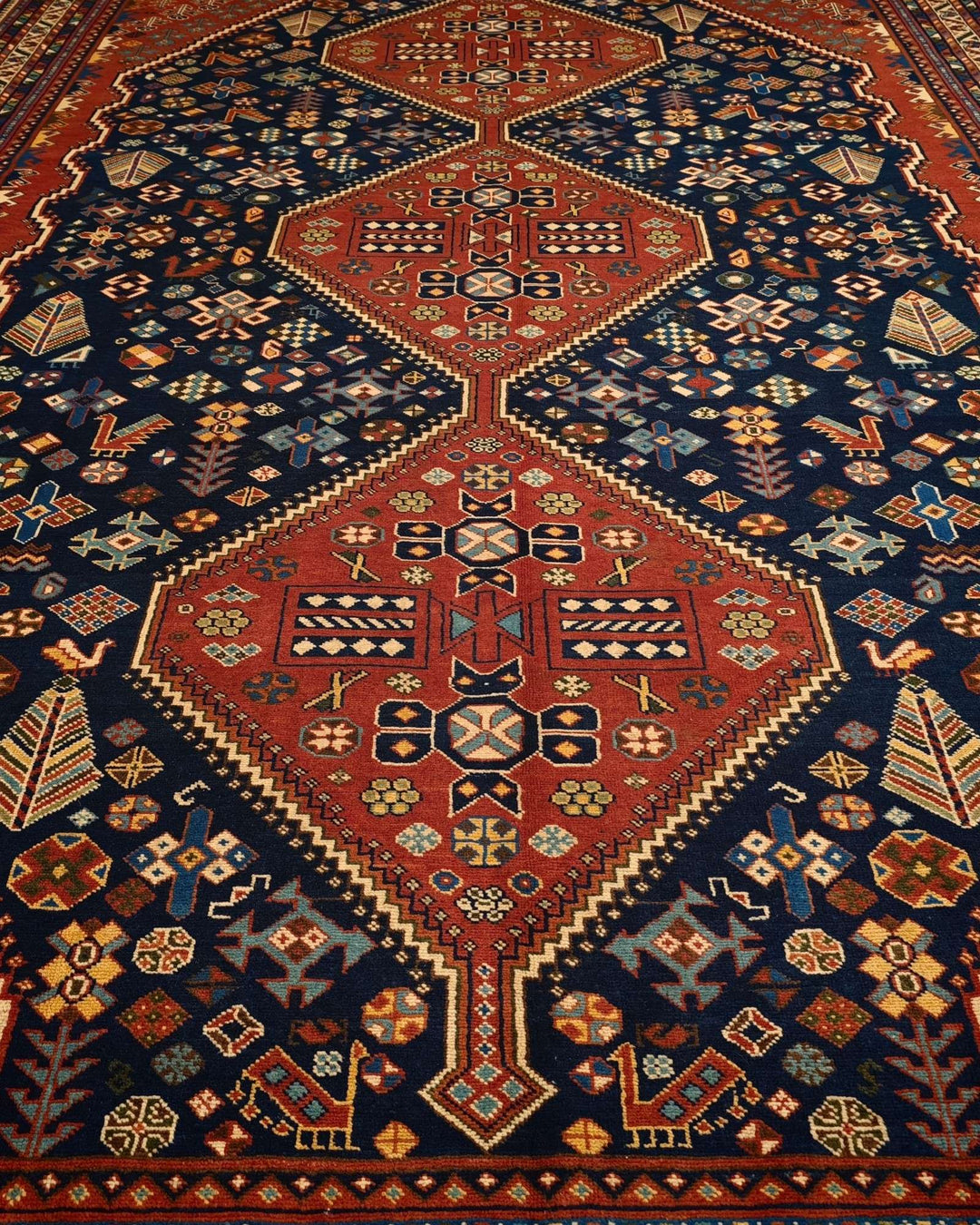 Border detail of navy and red Qashqai hand-knotted Afghan rug