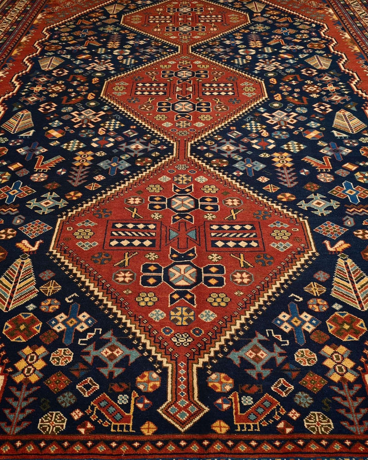 Border detail of navy and red Qashqai hand-knotted Afghan rug