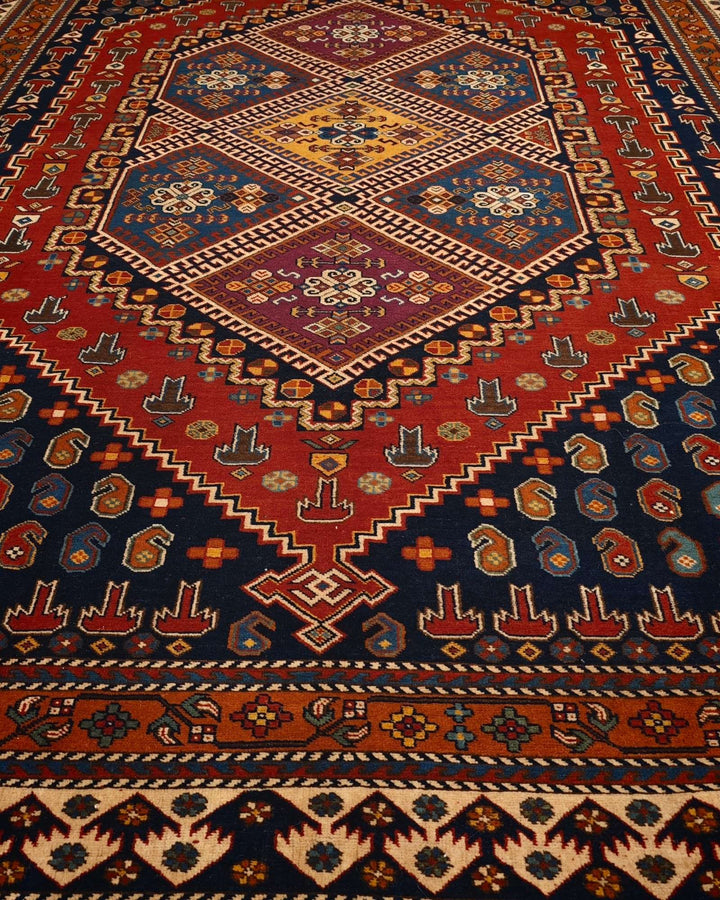 Border detail of navy and red tribal hand-knotted Afghan rug