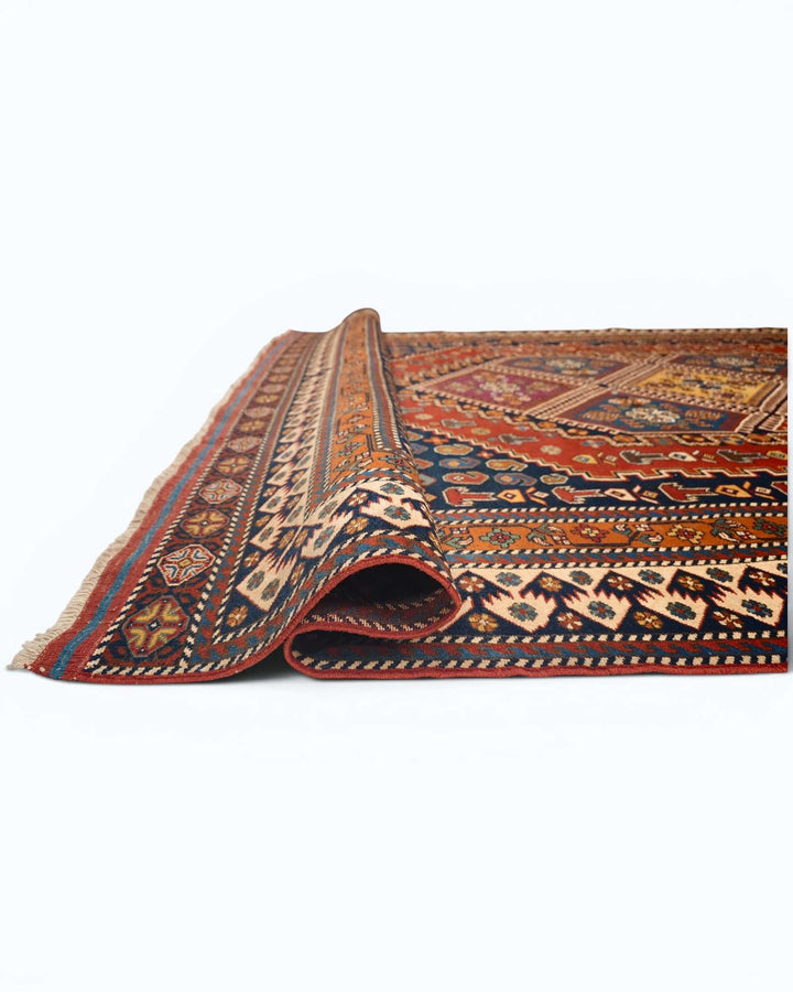 Corner of navy and red tribal medallion Afghan hand-knotted rug