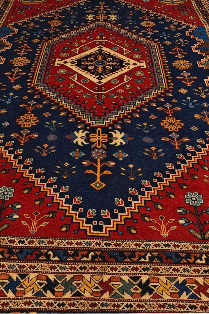 Border detail of navy and red Shiraz hand-knotted Afghan rug