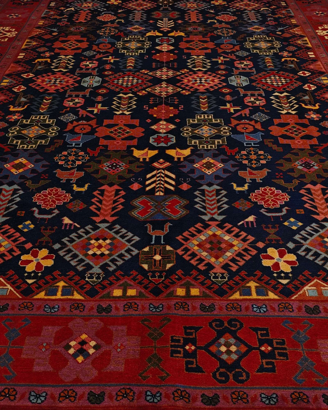 Border detail of navy and red Afshan hand-knotted Afghan rug
