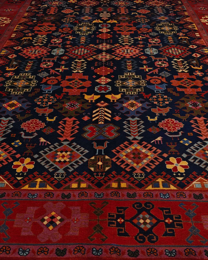 Border detail of navy and red Afshan hand-knotted Afghan rug