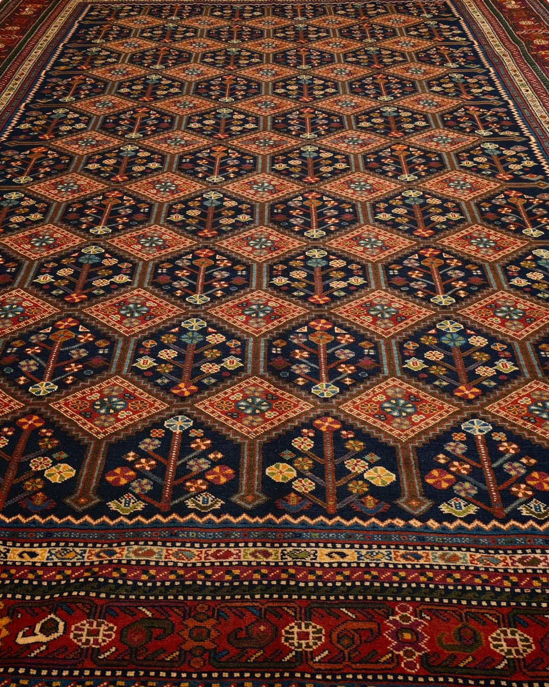 Border detail of navy and red garden lattice hand-knotted rug