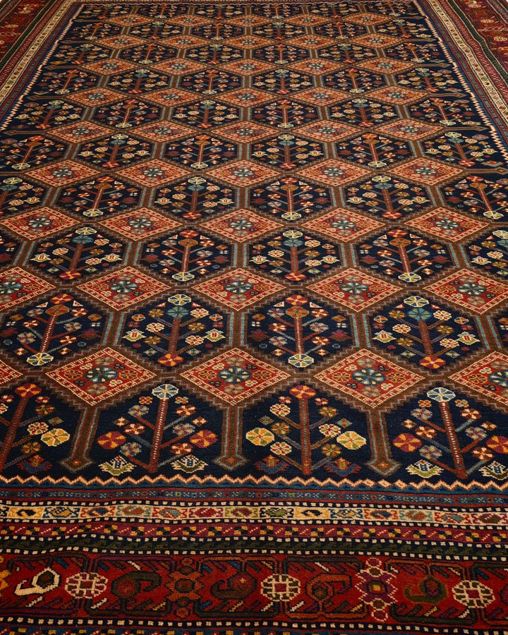 Border detail of navy and red garden lattice hand-knotted rug