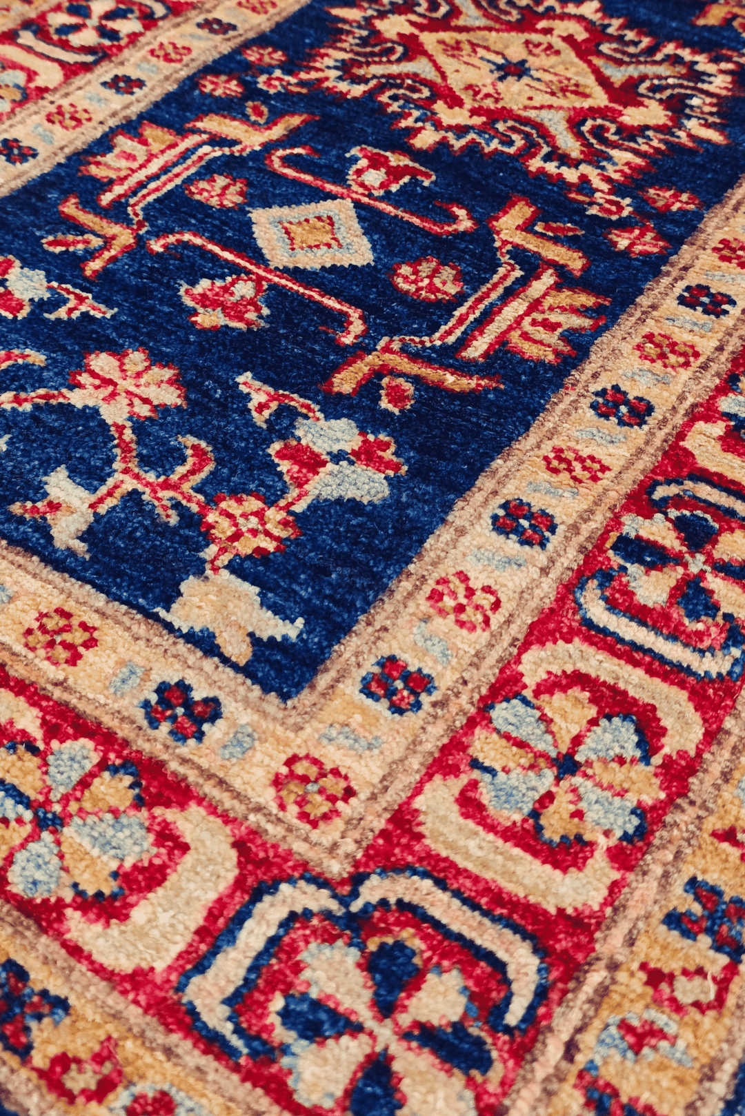 Caucasian medallion detail in navy and red on small Sherwan rug