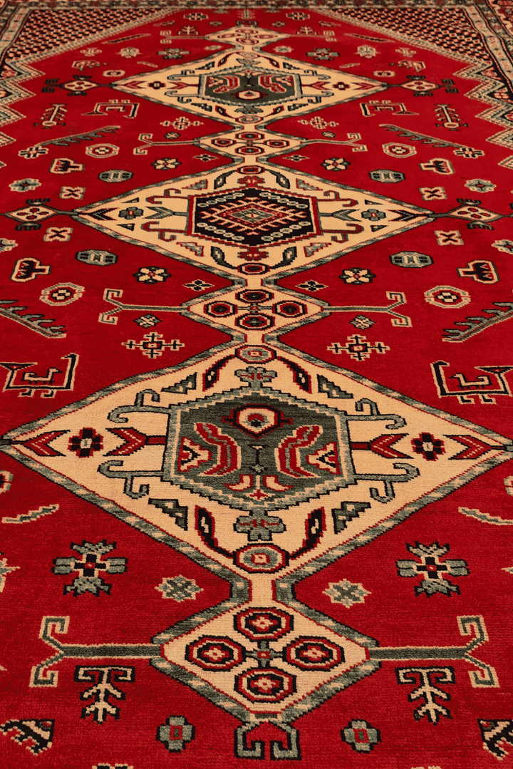 Border detail of red and navy Caucasian hand-knotted Afghan rug