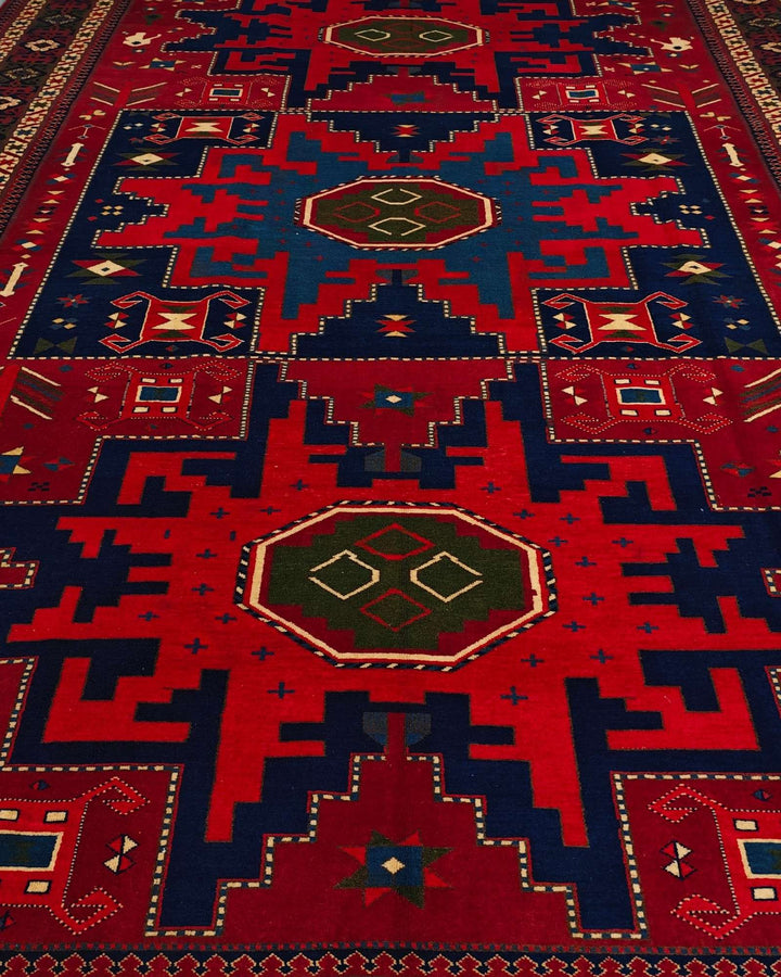 Border detail of red and navy Lesghi hand-knotted Afghan rug