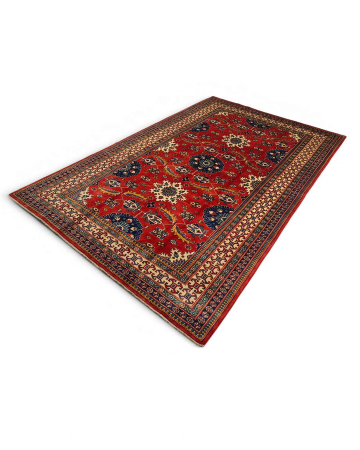 Hand-knotted wool pile of red Afghan Sherwan rug