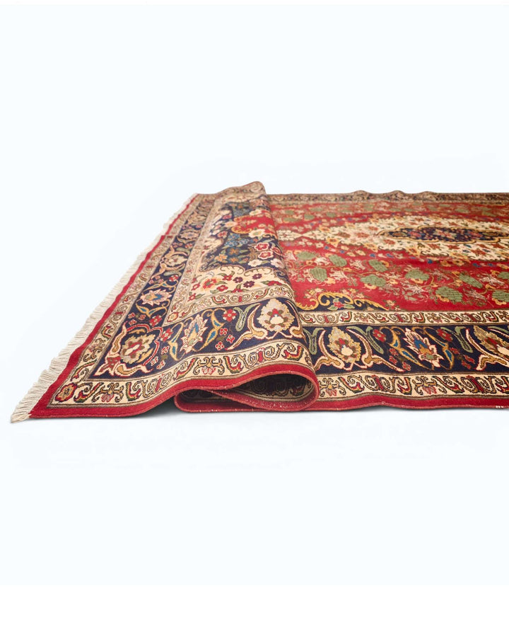 Corner of red and navy floral medallion Afghan hand-knotted rug