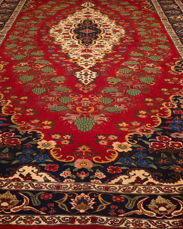 Hand-knotted wool pile of red floral medallion Afghan rug